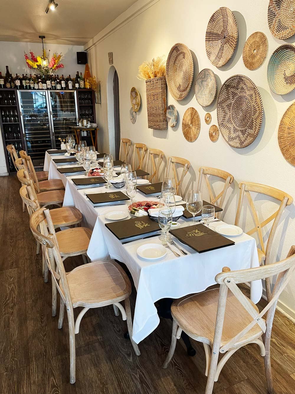 Artisan French chef tasting sauce at copper pot in Bistro Moulin kitchen
