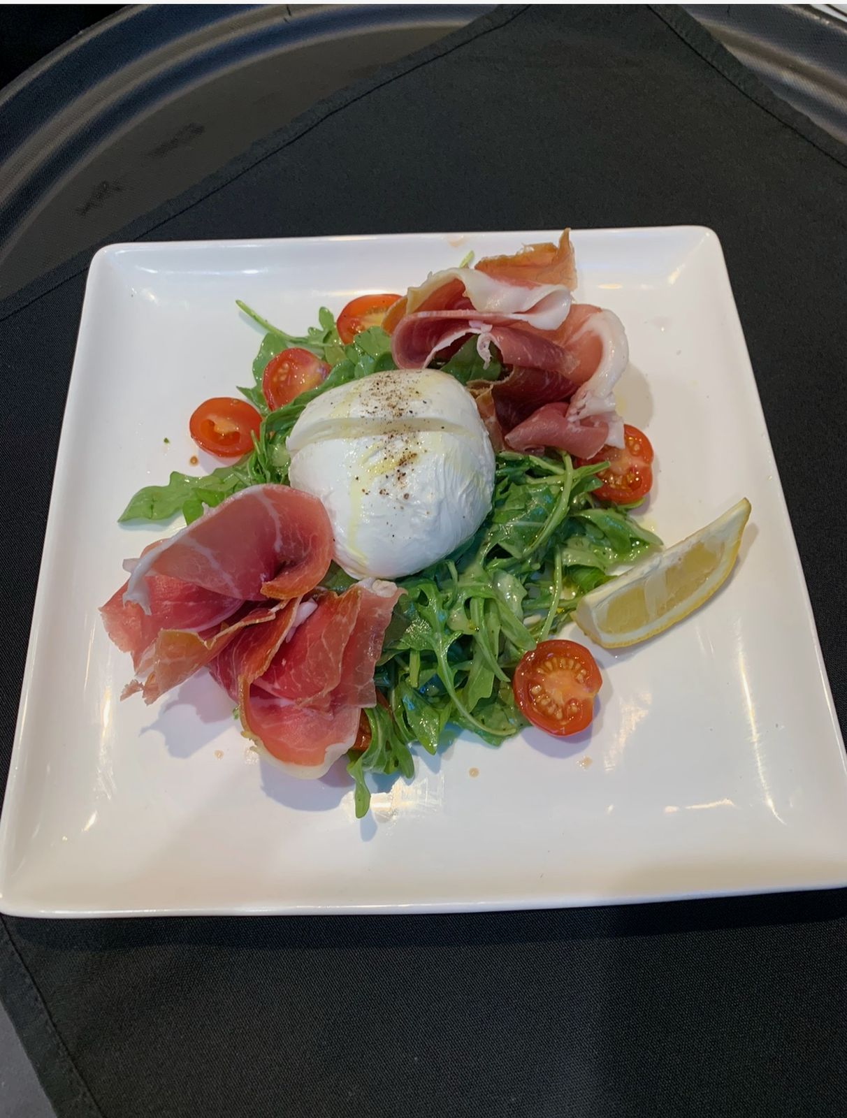 Burrata with prosciutto and tomatoes