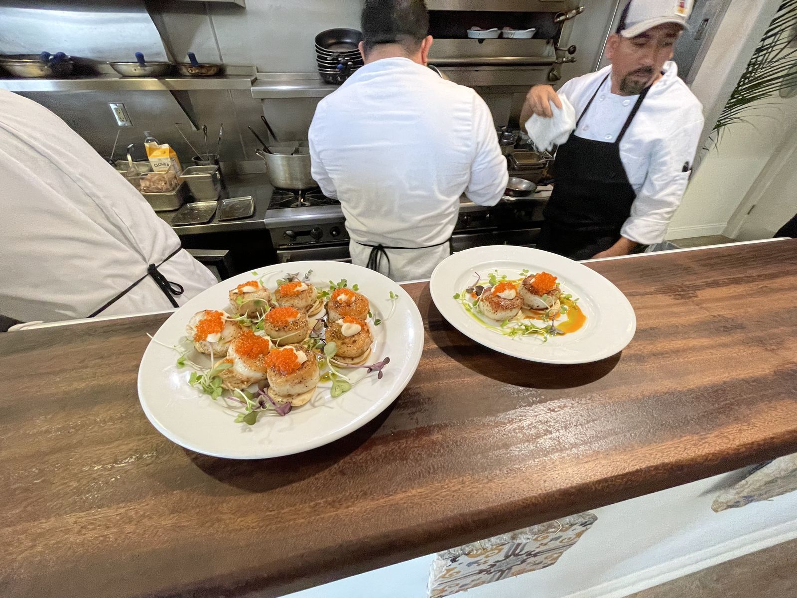 Chefs plating dinner at the pass