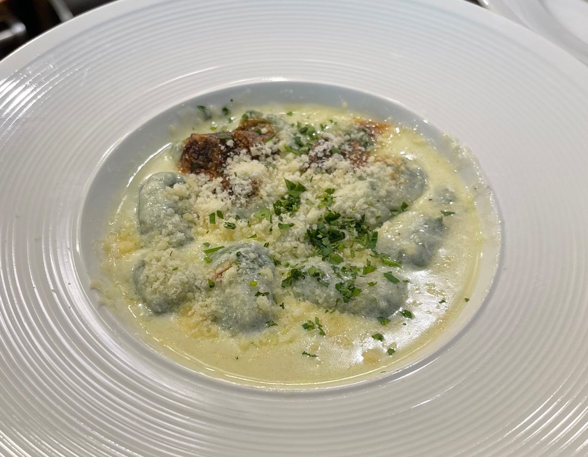 House-made spinach gnocchi in parmesan cream sauce at Bistro Moulin, Monterey